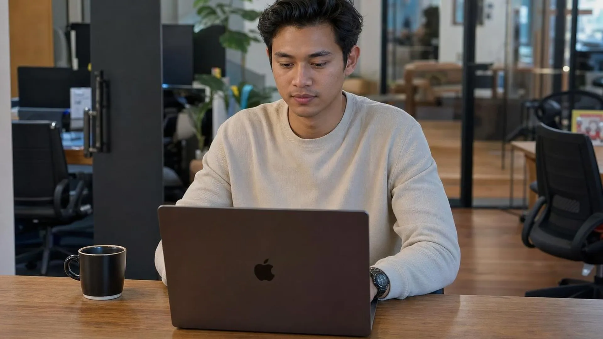 Leidinggevende kijkt peinzend naar laptop op kantoor